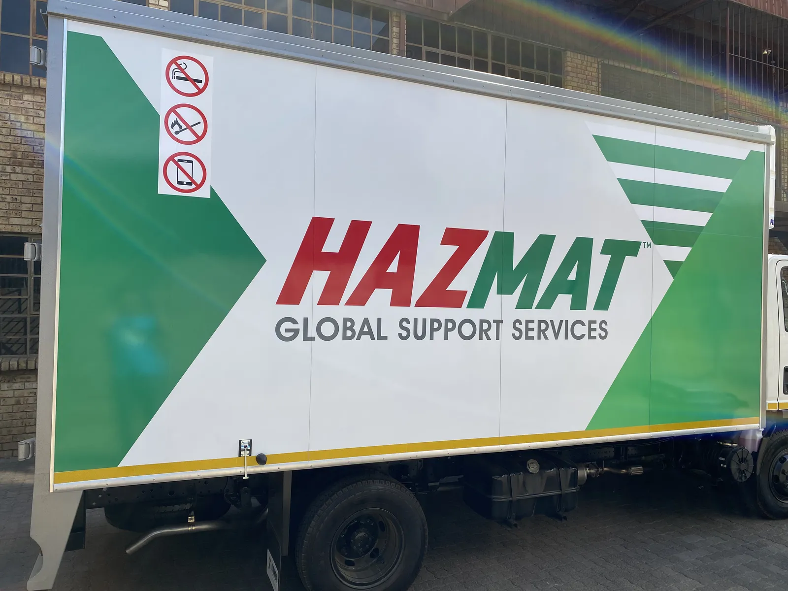 Hazmat branded Isuzu truck side view
