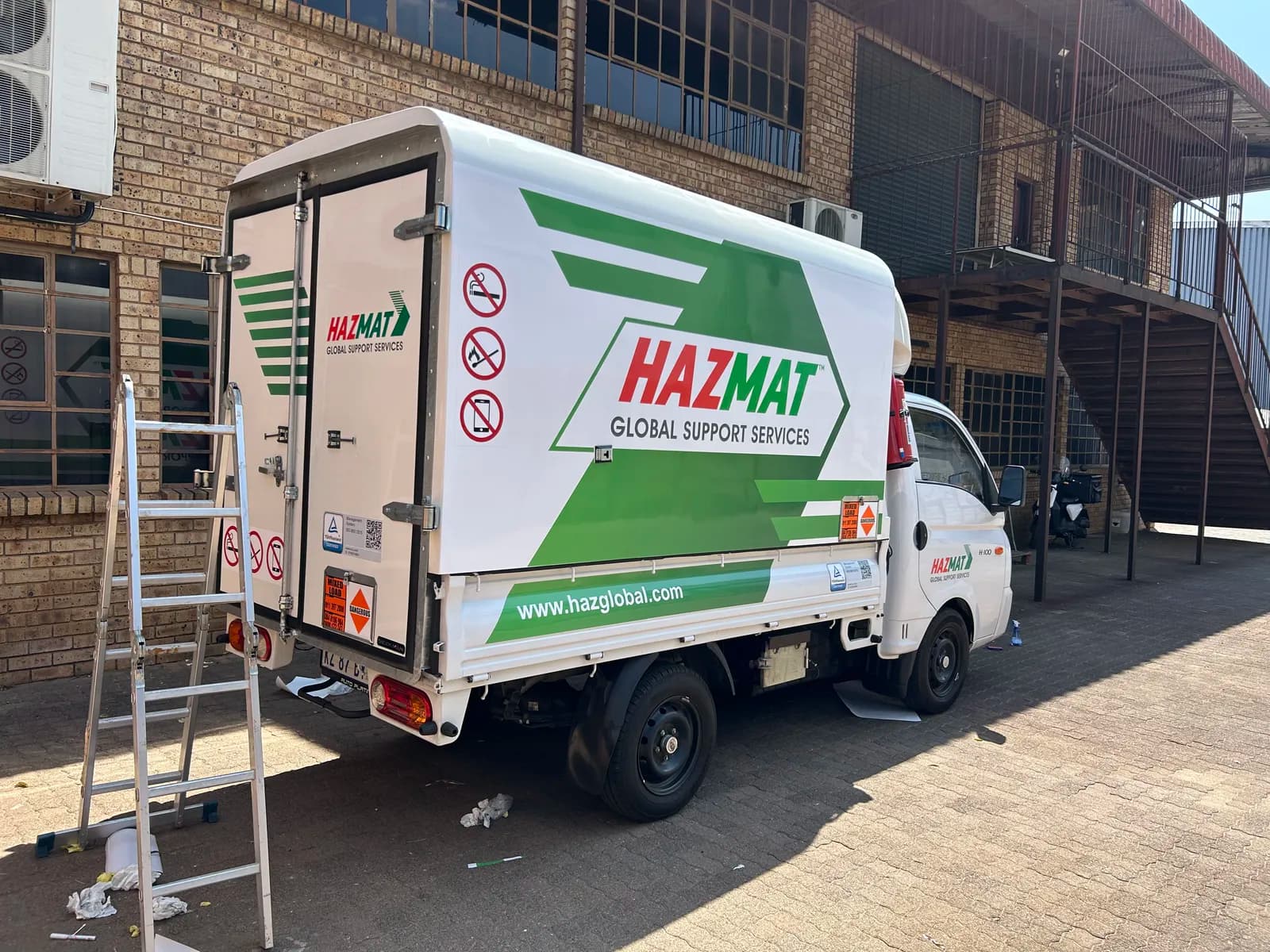 Hazmat branded truck rear quarter view